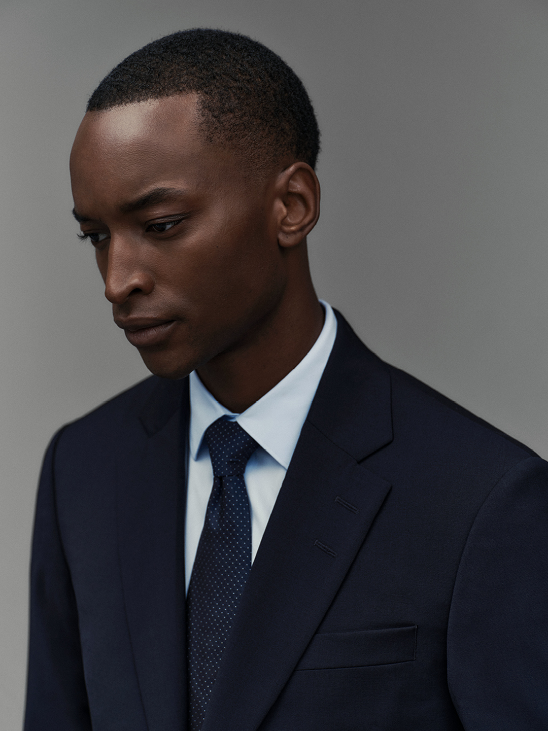 Man in blue shirt and suit jacket